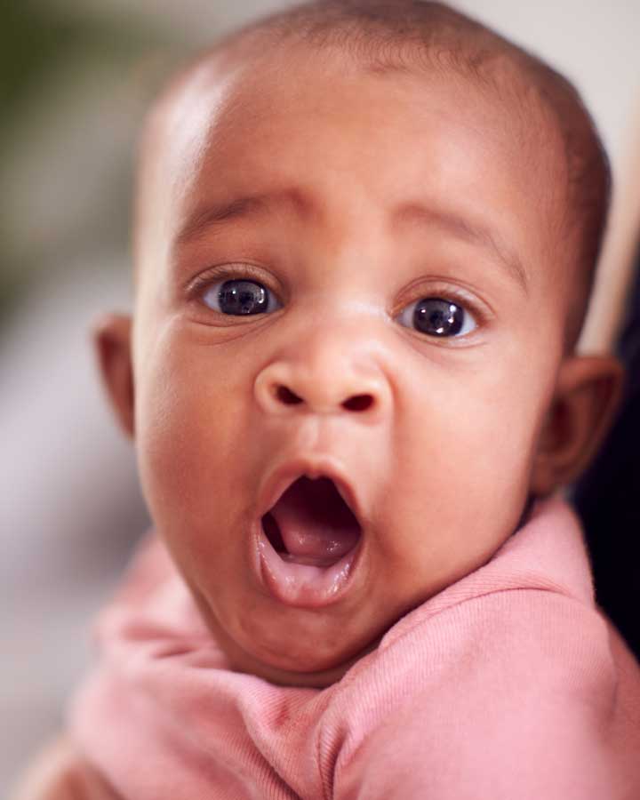 Young baby yawning.